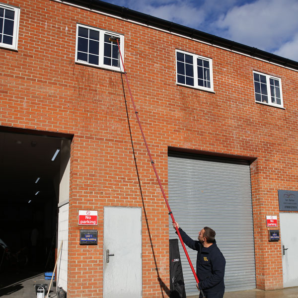 High reach pole being used to clean outside windows of commercial offices/industrial units.