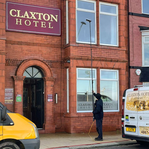 High reach pole system being used to clean the windows of the Claxton Hotel.